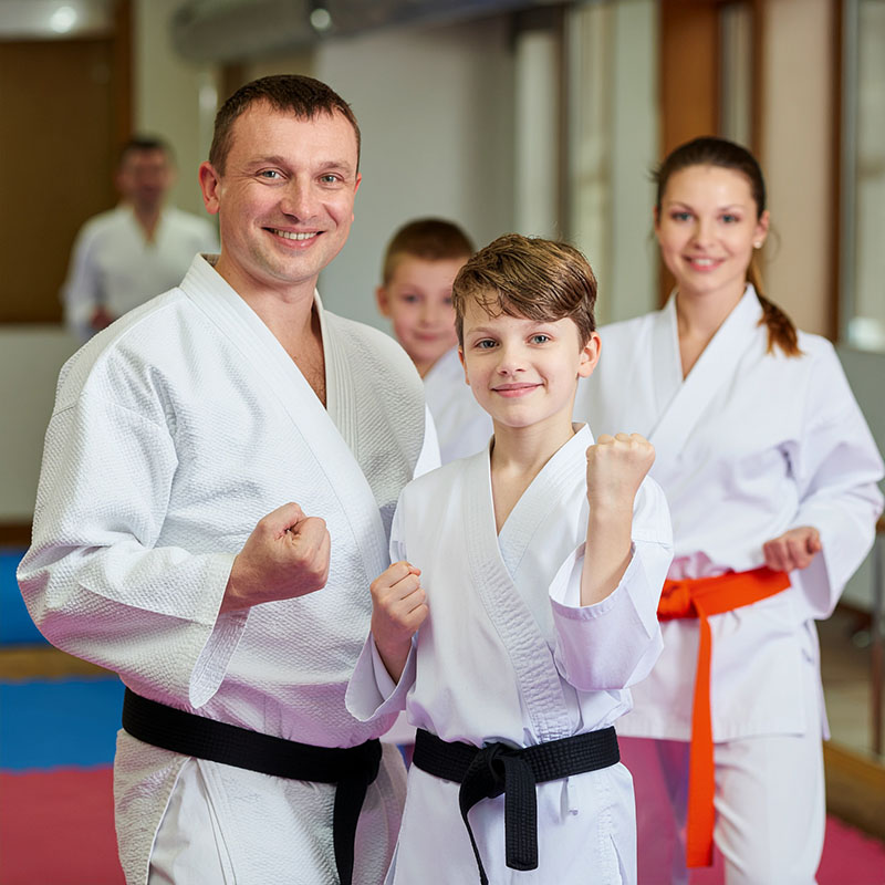 martial arts family in a dojo