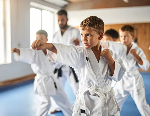 Confident martial arts boy punching.